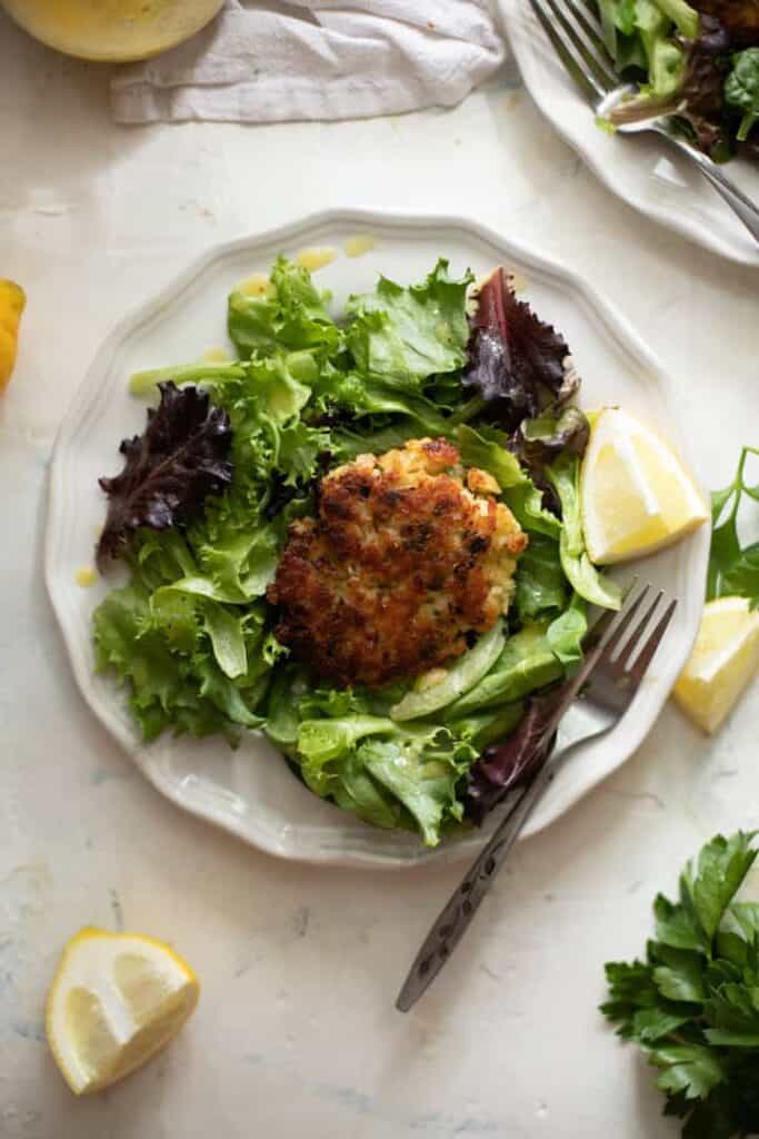 fish cake with haddock over salad greens
