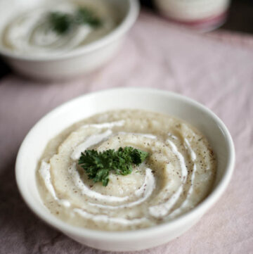 bowl of gluten free potato soup garnished with parsley
